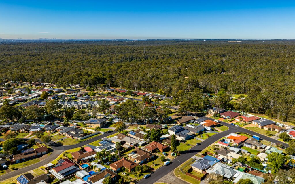 Aerial view of a housing estate meeting bushland