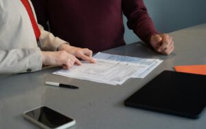 Two people going through paperwork at a table
