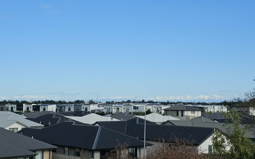 A row of newly built houses under a clear sky