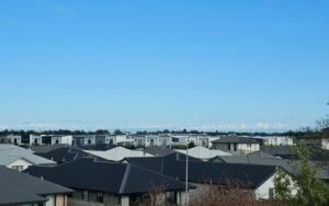 A row of newly built houses under a clear sky